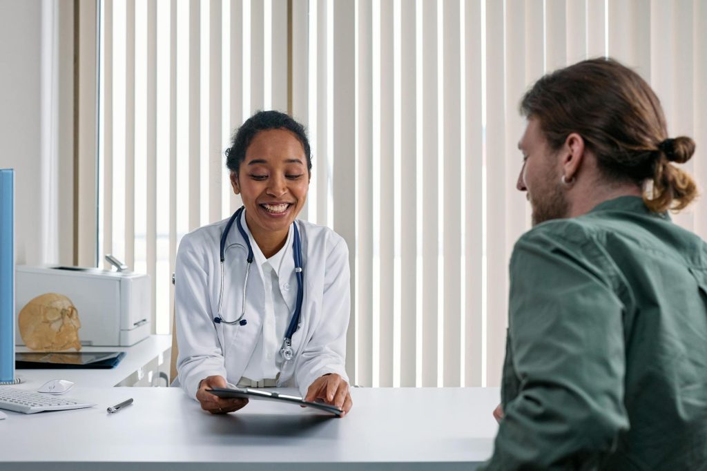 Board-certified dermatologist consulting with patient about skin condition treatment at Elect Dermatology in New Braunfels TX